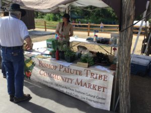market stand at Bishop Paiute Community market selling fresh produce