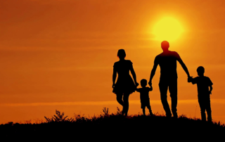 silhouettes-of-happy-family-running-on-a-sunset